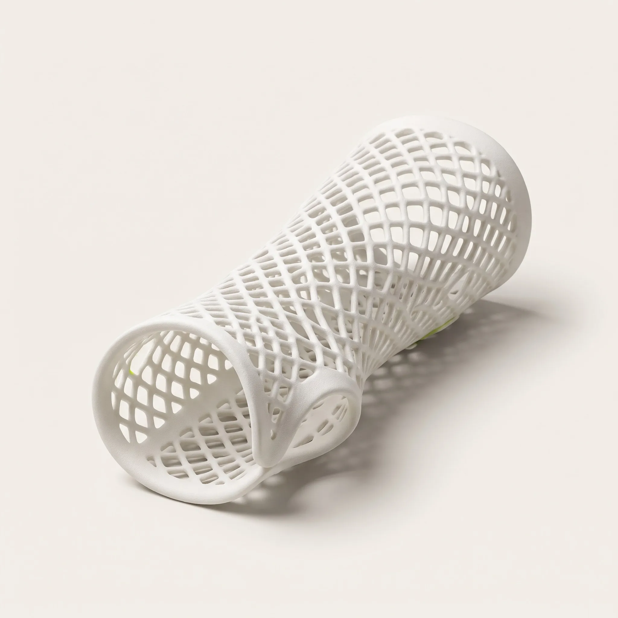 3D-printed wrist splint with a white lattice structure and a green accent